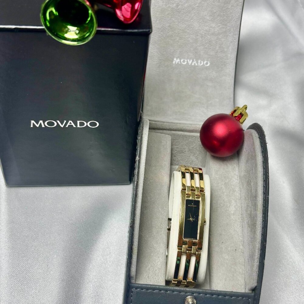 Movado Esperanza lady's Baguette shaped black dial gold tone watch.